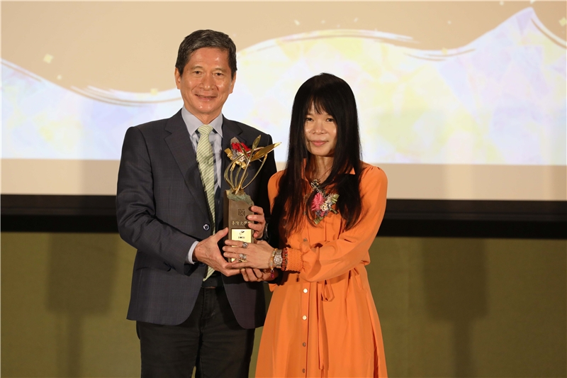 文化部長李永得（左）頒贈金典獎年度大獎獎座予得主鍾文音